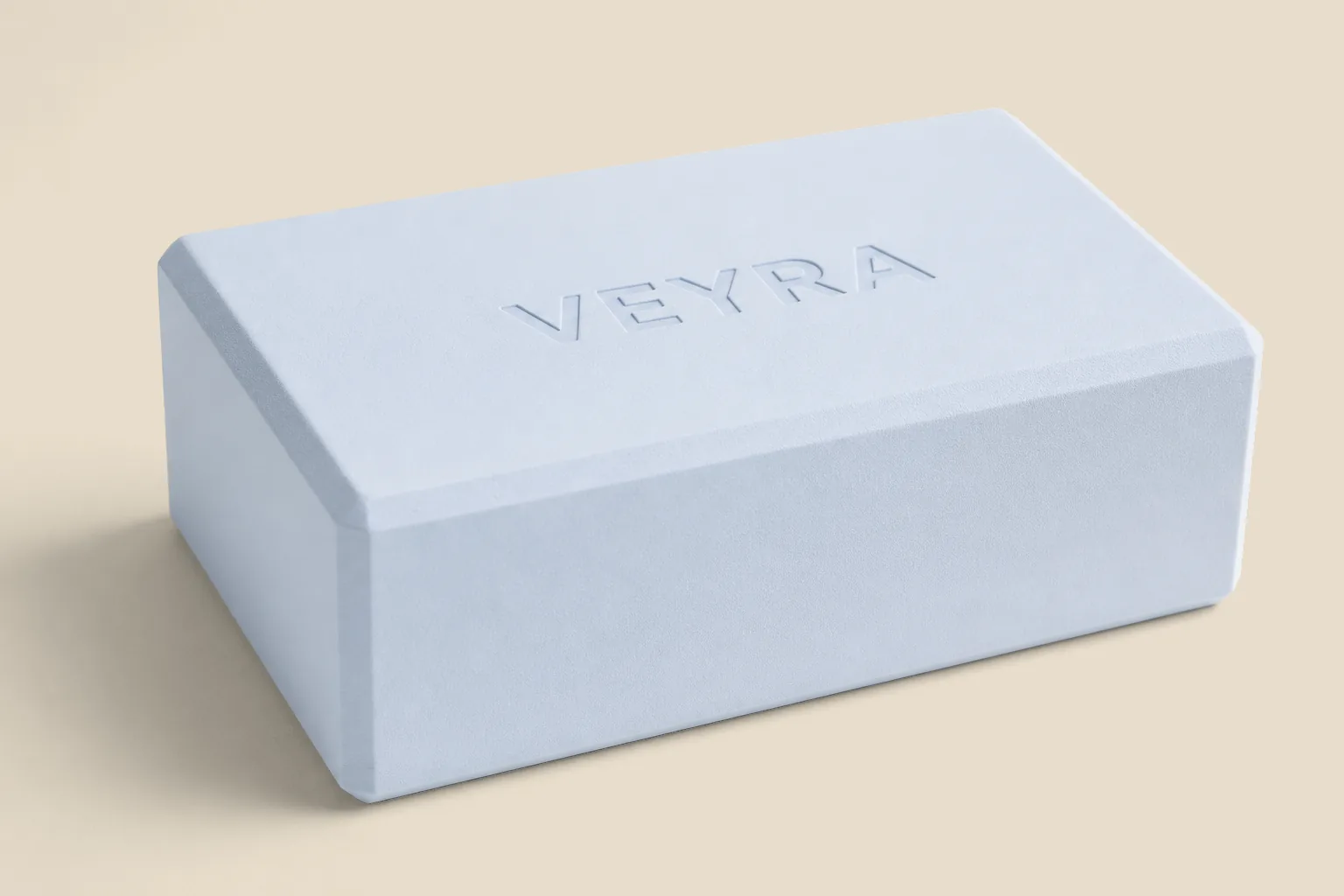 The VEYRA Block, a powder-blue yoga block with custom logo branding