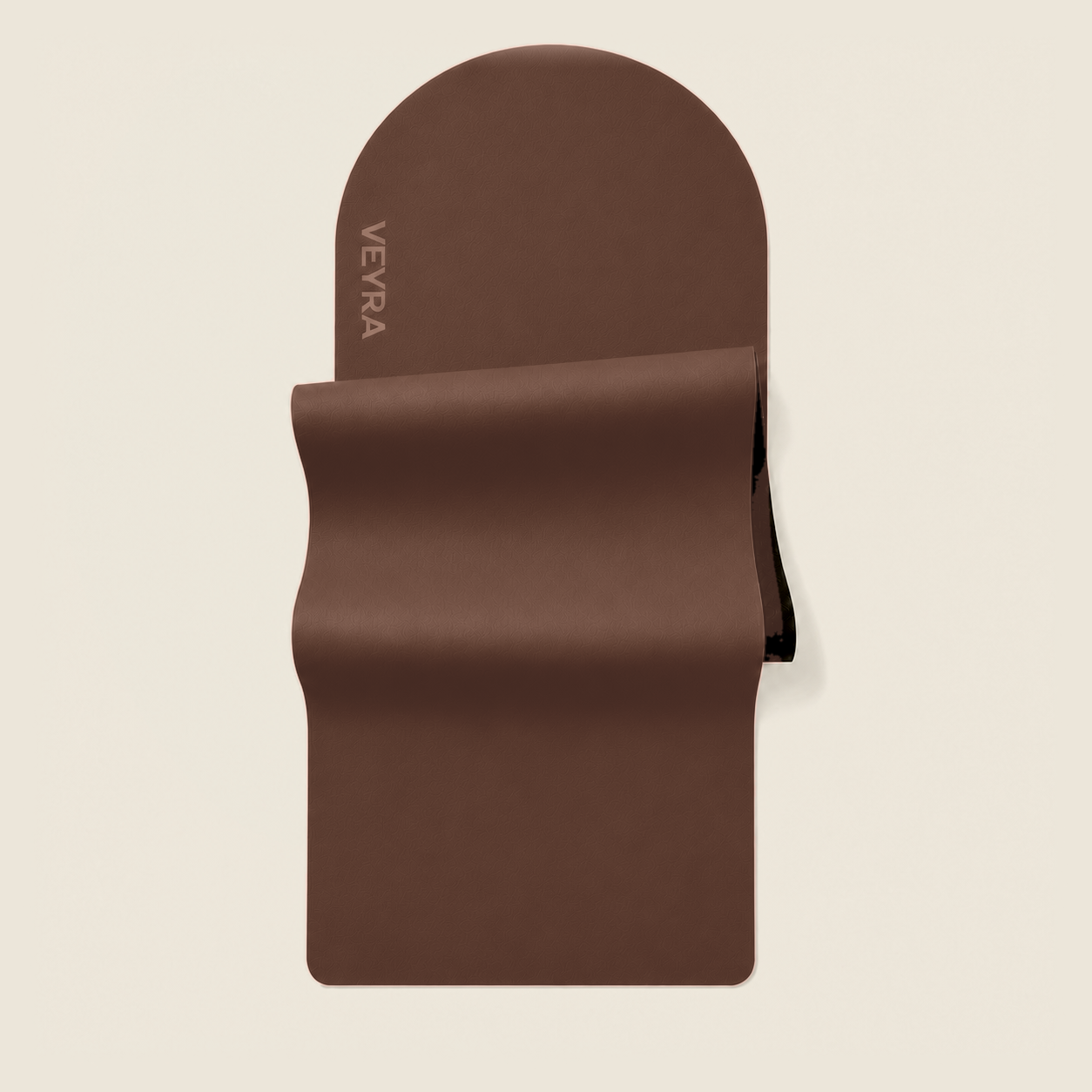 The VEYRA Mat in Pantone 7596 C mocha brown on the unified warm-ivory studio background
