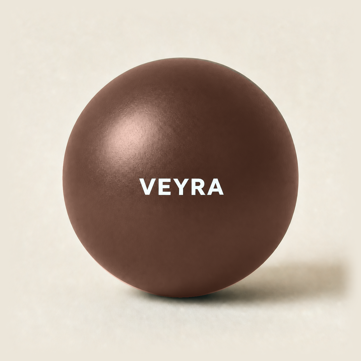 The Pantone 7596 C mocha VEYRA Pilates Ball with a crisp white logo