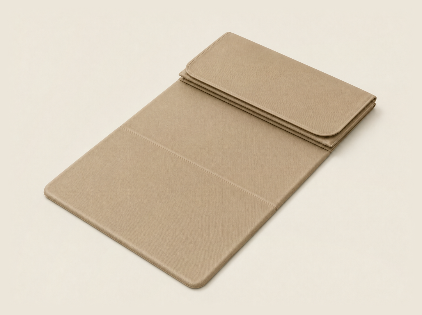 The Travel Mat in cloud cream, shown folded and partially unfolded